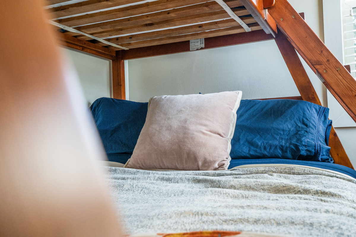 Cozy full-size bed on the bottom of the bunk bed.