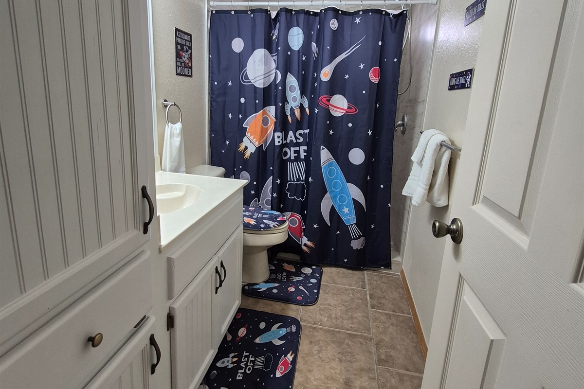 Ground floor bath servicing the bunk room and pool areas with walk-in shower with bath toiletries provided. 