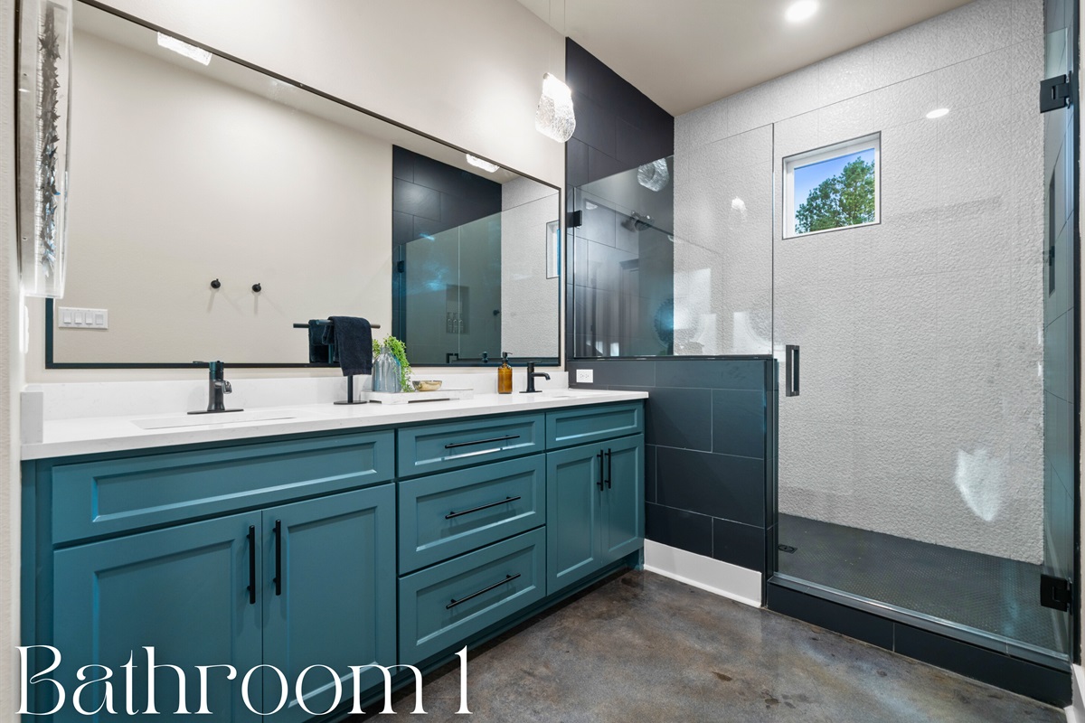 This bathroom boasts dual sinks with modern black fixtures, combining practicality with sleek, contemporary design.