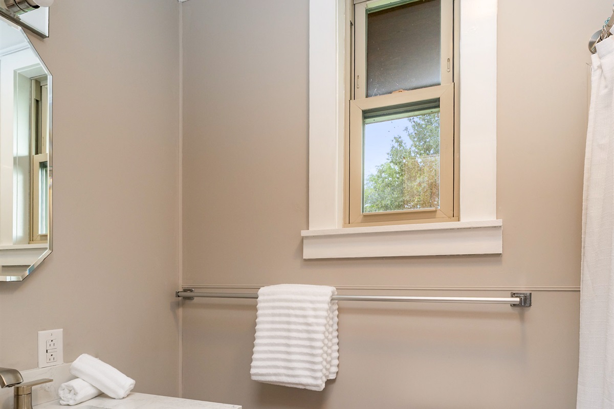 Fresh and modern bathroom featuring a sleek vanity, updated fixtures, and a clean design perfect for relaxation.