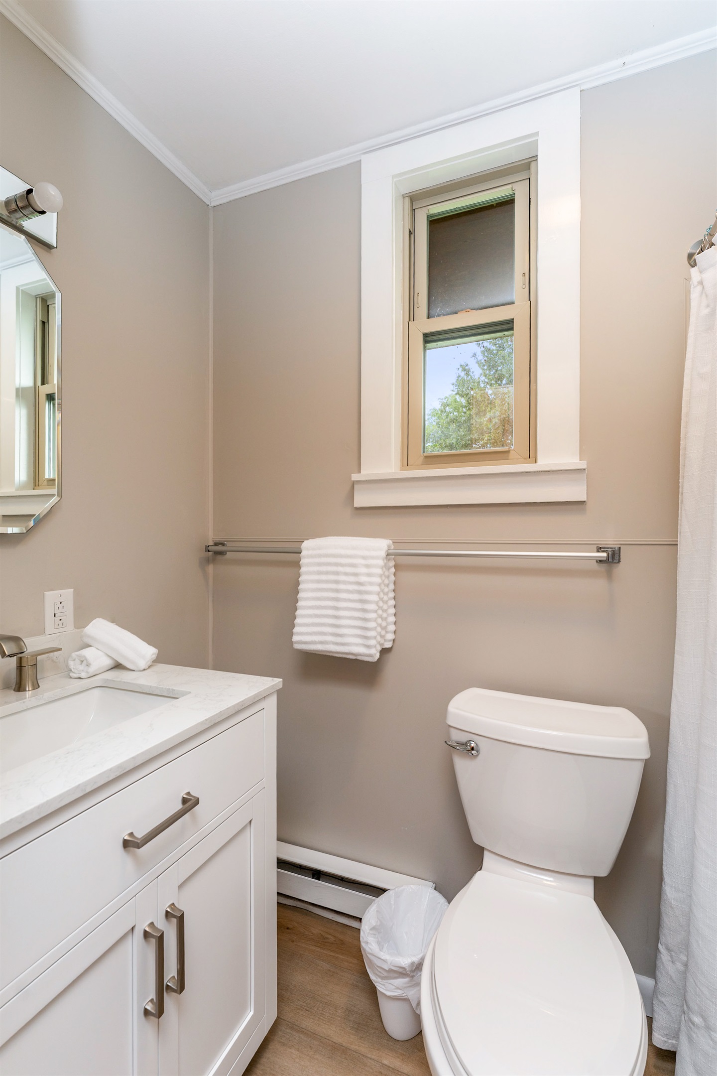 Fresh and modern bathroom featuring a sleek vanity, updated fixtures, and a clean design perfect for relaxation.