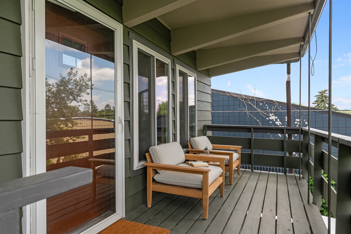 Escape to the other side of the balcony, where a private seating area for two offers a quiet spot to relax and enjoy the view together.