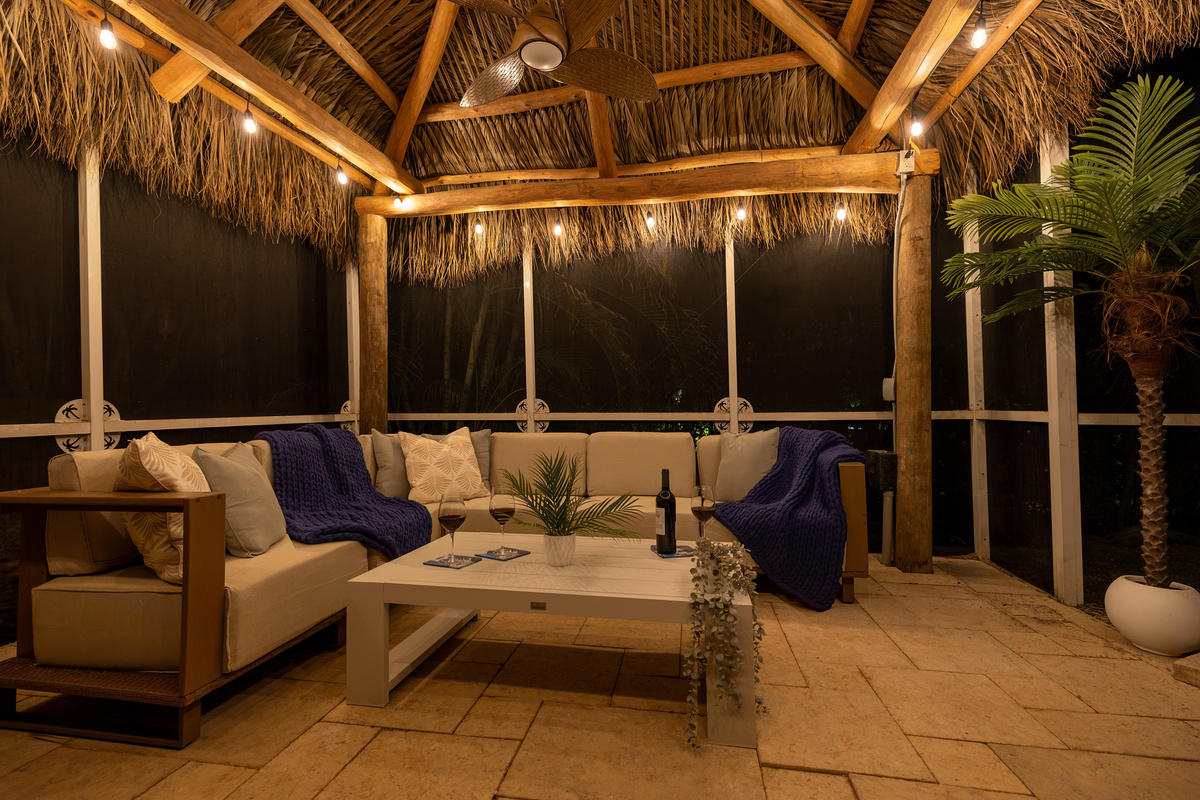 Lounge in the tiki hut next to the pool at night.