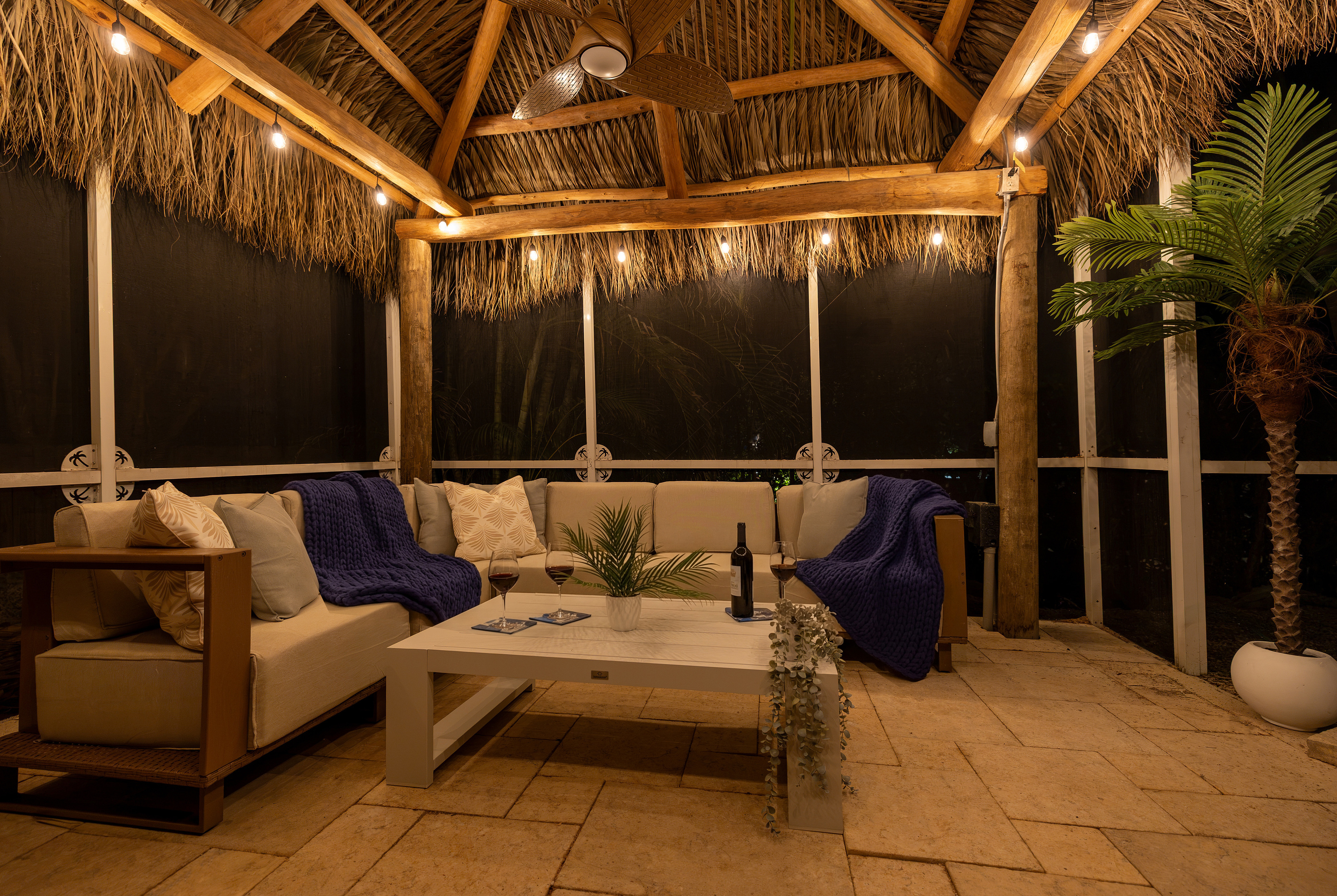 Lounge in the tiki hut next to the pool at night.
