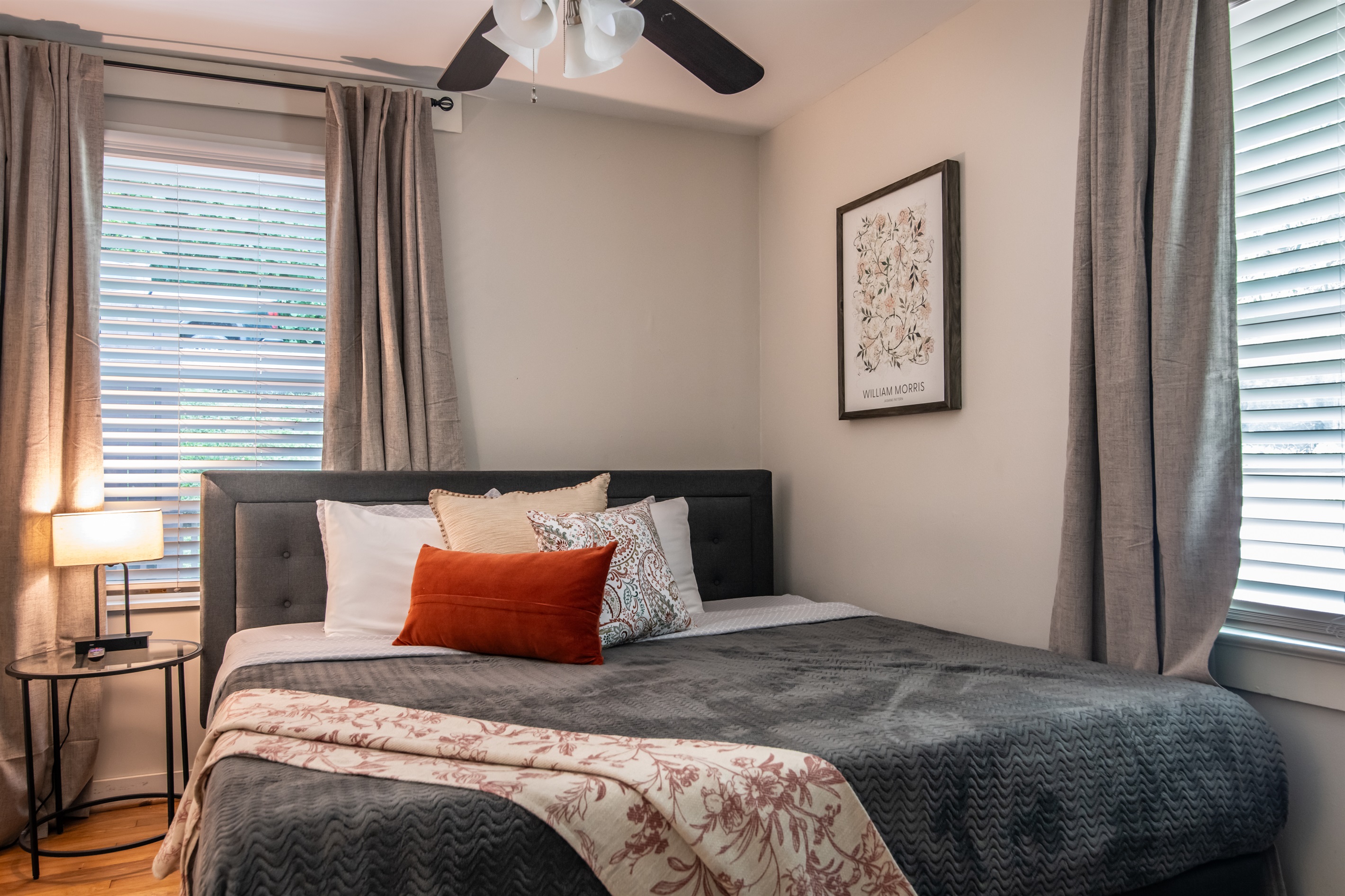 Spacious bedroom featuring a queen-sized bed, blackout curtains, and soft bedding for a restful night’s sleep.