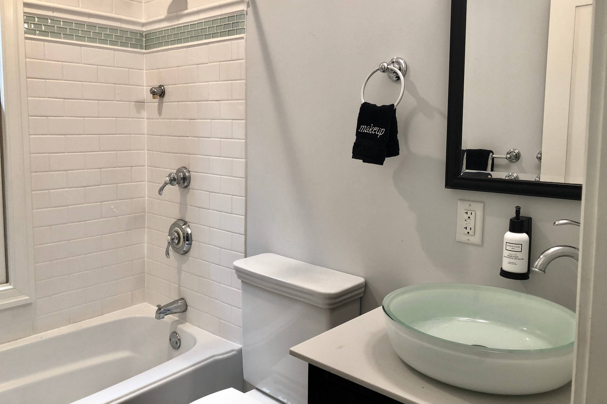 Full guest bath featuring a spa-like vessel sink, premium amenities, and a shower/tub combo—perfect for a relaxing reset after a day in DC.