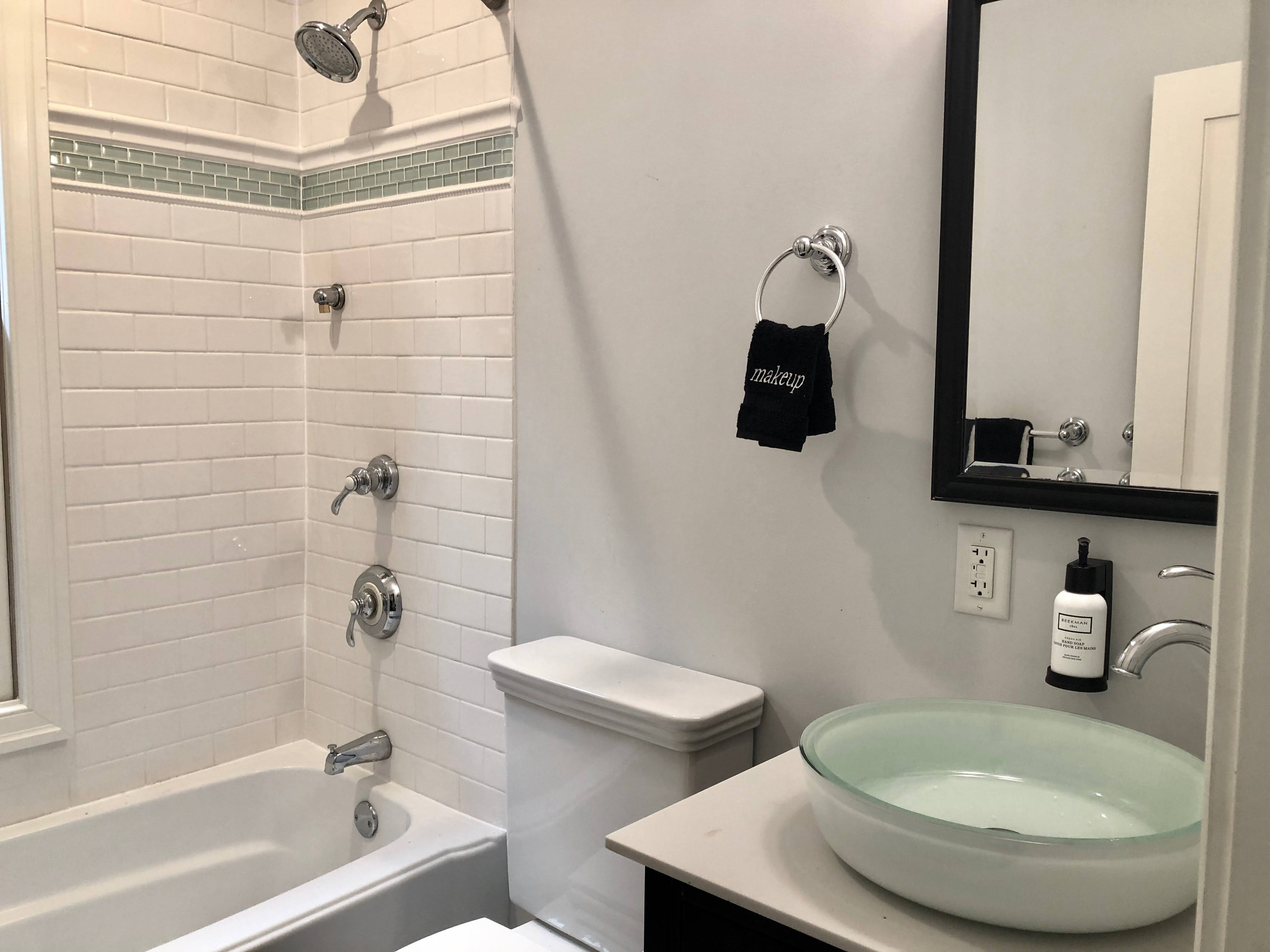 Full guest bath featuring a spa-like vessel sink, premium amenities, and a shower/tub combo—perfect for a relaxing reset after a day in DC.