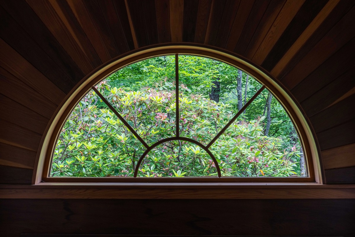 Wake up to serene views of lush greenery framed perfectly by unique architecture.