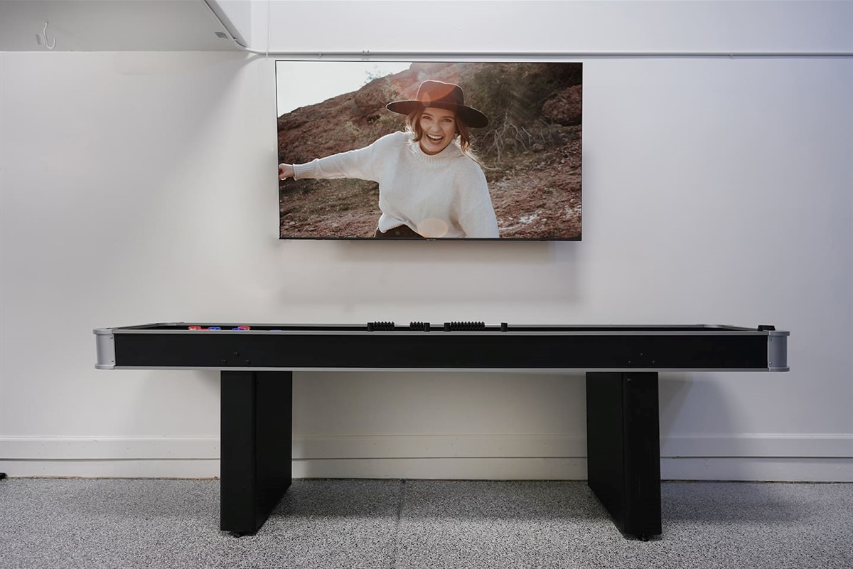 Air conditioned and heated garage space includes tons of games like foosball, air hockey, and shuffleboard. Watch TV on the large LoveSac couch if you'd like.