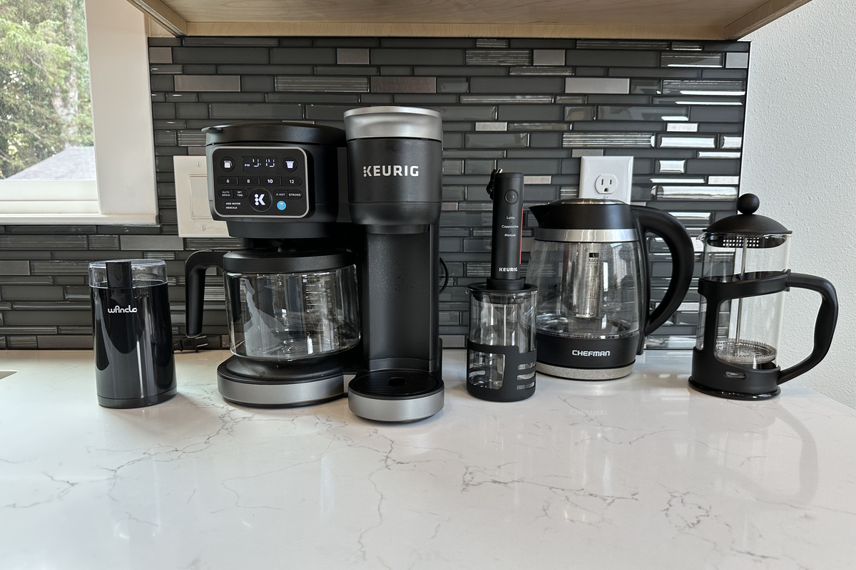 Keurig, drip carafe, French press and an electric kettle — the coffee bar is up before you are.