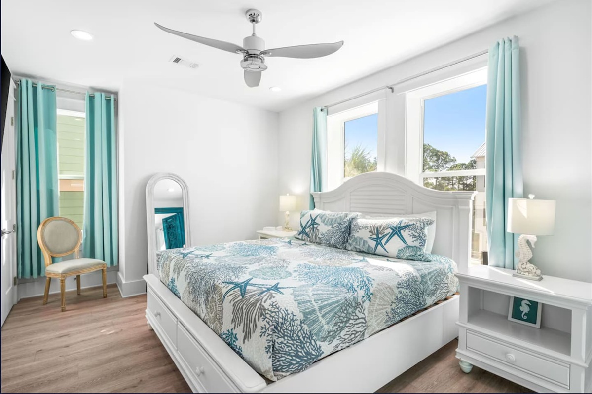 Master Suite: King bed, XL Smart TV & a stunning antique French door with bespoke seahorse handles. Enjoy a bright, airy space with a full closet, large mirror, and ample storage in the integrated bed drawers and coastal bedside table.