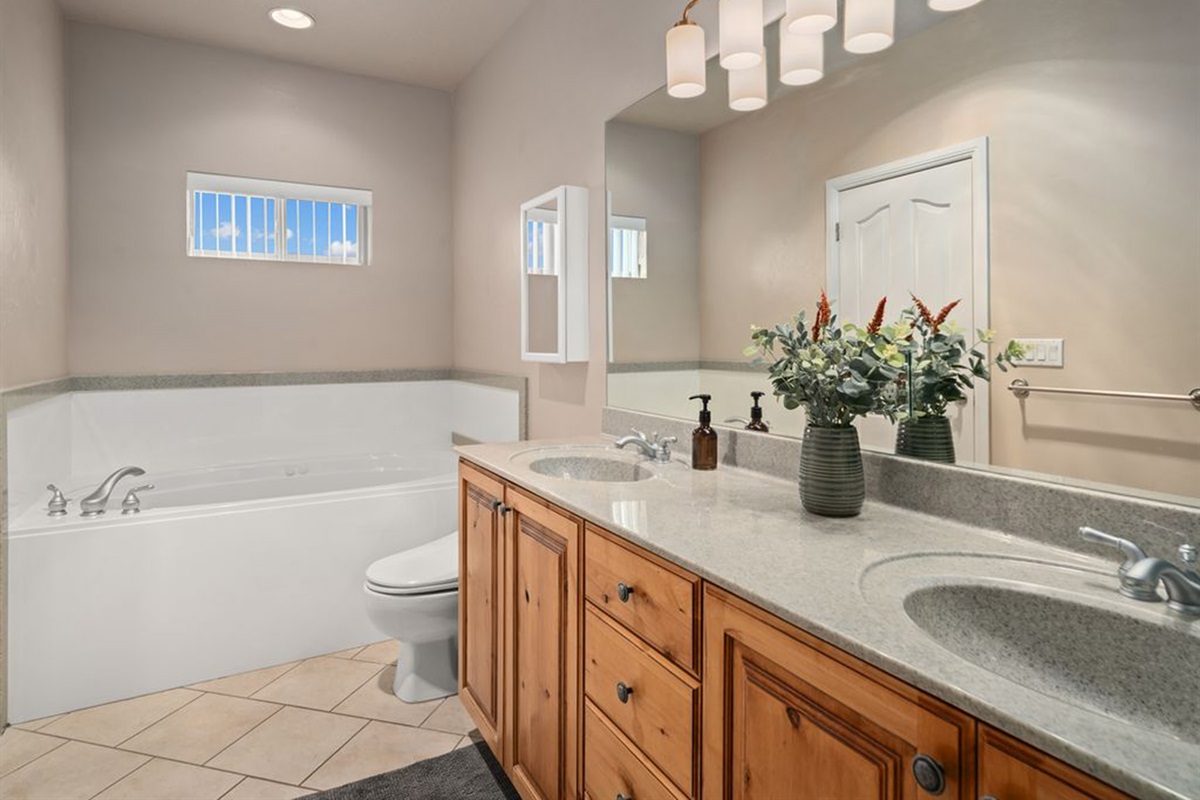 Spa-inspired primary bathroom with soaking tub, double vanity, and elegant finishes.