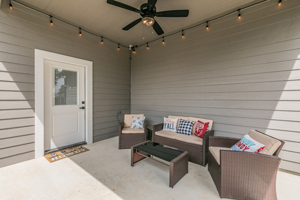 Covered patio with seating and fan