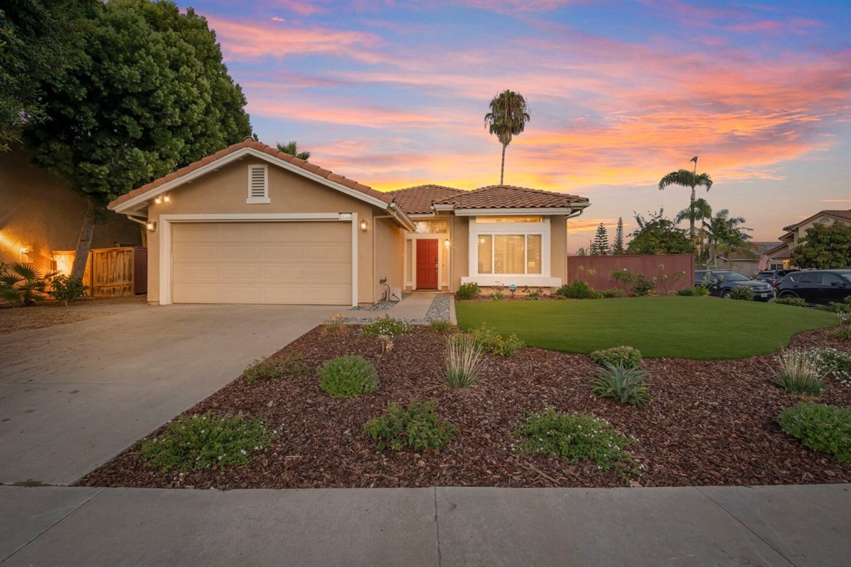 The front yard boasts beautiful landscaping with lush greenery and vibrant flowers. A smart keyless entry adds modern convenience. The two-car garage and driveway provide ample parking and easy access. There is also plenty of street parking.