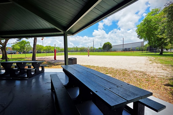 Covered picnic pavilion and outdoor gathering space at Floranada Park across the street