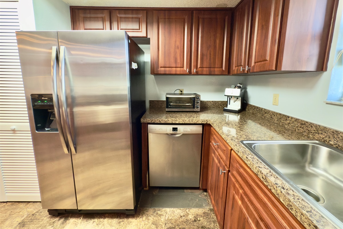 This stylishly appointed galley-style kitchen blends rich, classic finishes with modern amenities to create the perfect space for preparing meals.
