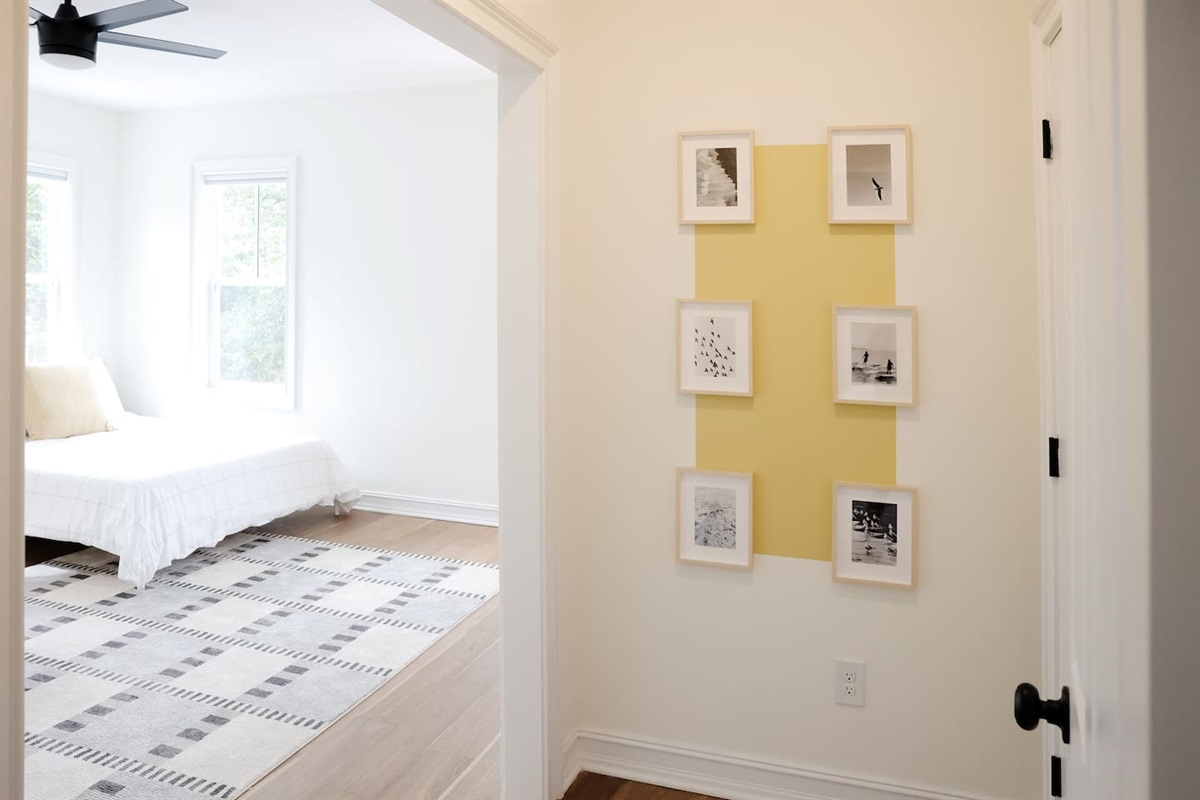 The spacious "sunrider room" features two queen beds, a spacious double-door closet, a full bath with a shower, smart TV and coastal photography. 