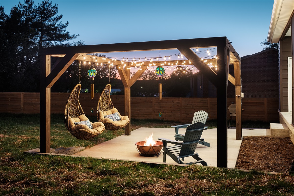 Guests love how this inviting backyard transforms from a daytime sanctuary to a nighttime haven, glowing with warmth and tranquility.