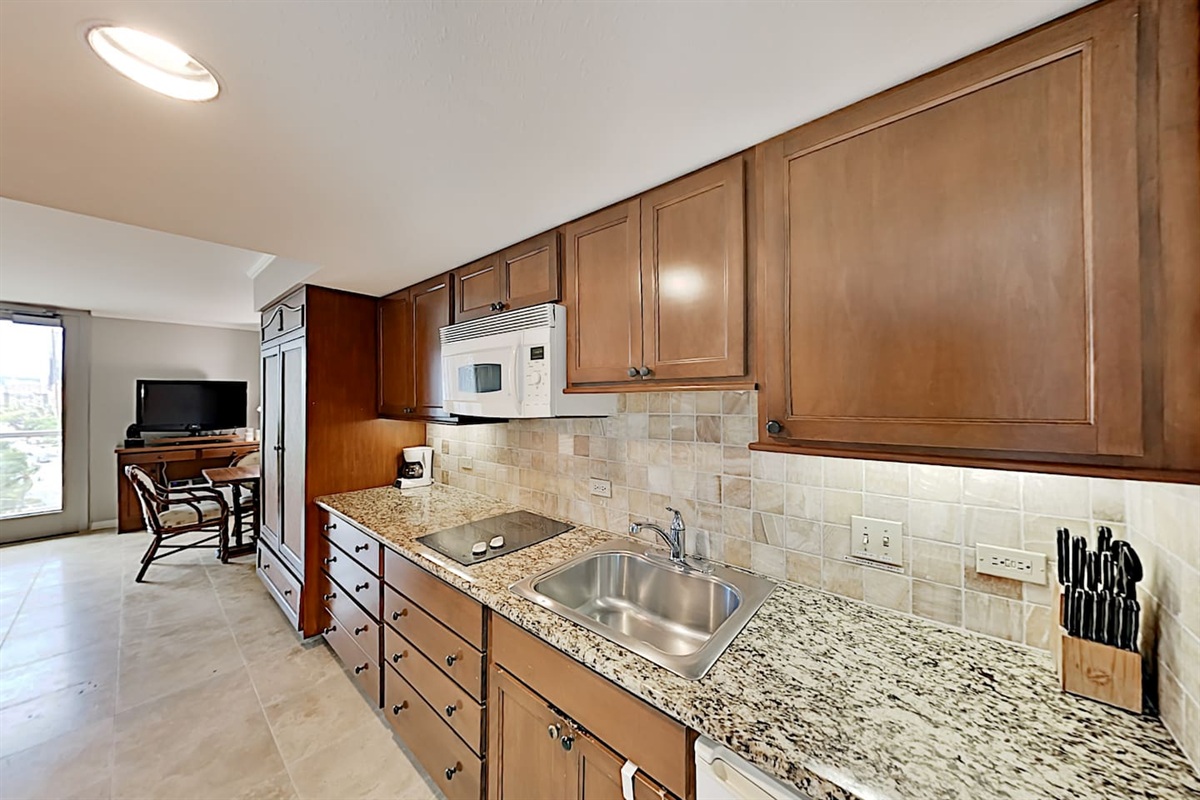Kitchenette with ample counter space, 2 burner stove, microwave, sink, mini fridge