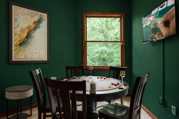 Cozy poker room with Appalachian Trail decor and streaming-ready TV.