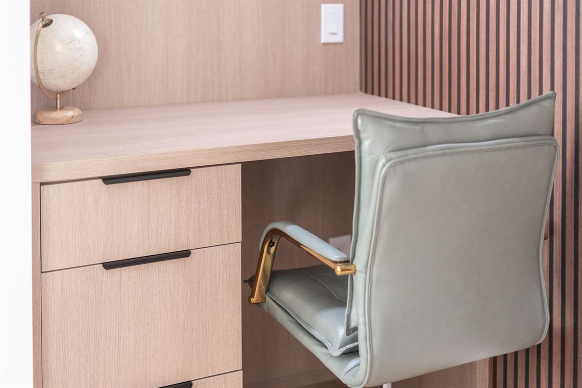 Comfortable office chair with gold accents adds a stylish touch to your work corner.