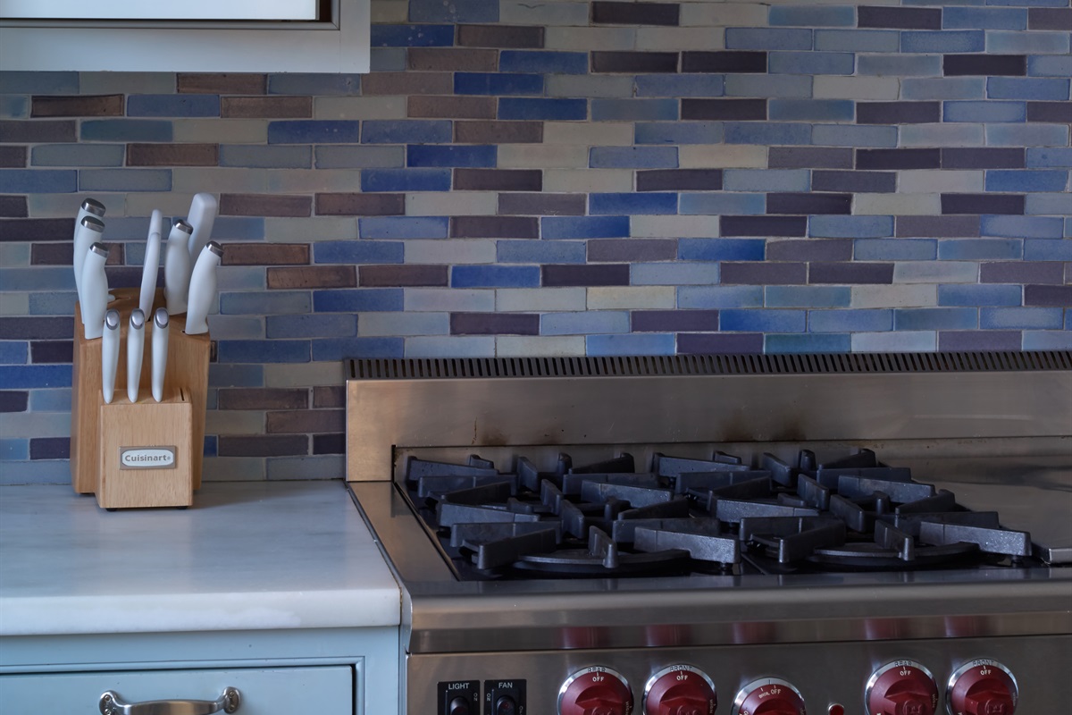 Premium stainless steel appliances, including a high-end gas range, are ready for your home-cooked meals.