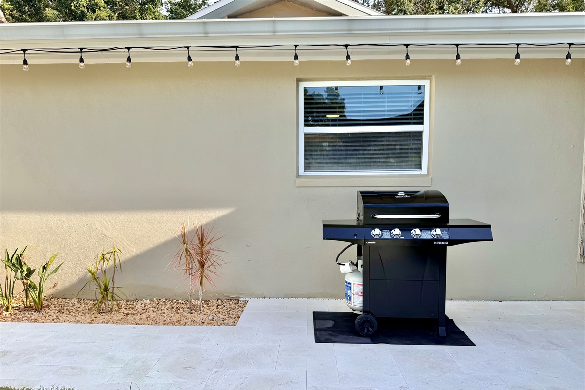 Relax, grill, and dine al fresco in this outdoor oasis featuring a sparkling heated pool and cozy dining area.
