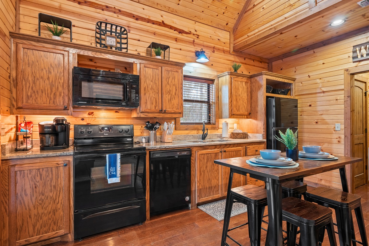 Another view of the kitchen highlights the generous counter space and open layout, giving everyone room to cook, gather, or simply hang out together.