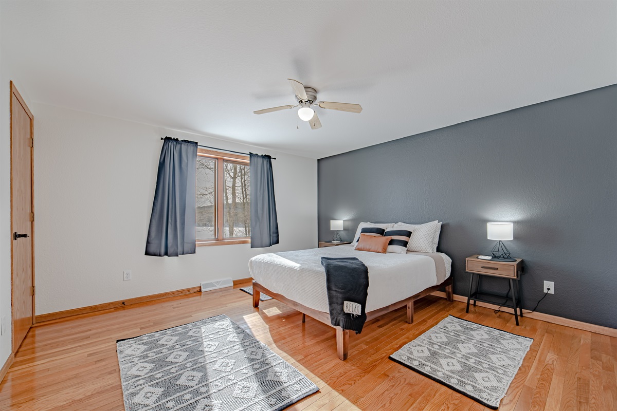 This guest bedroom has a walk-in closet, views of the lake and a comfy queen size bed!