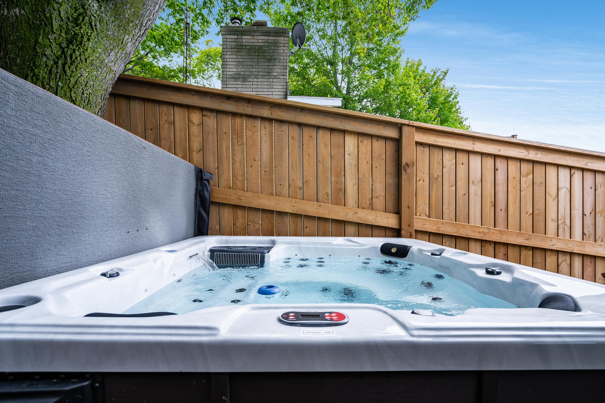 Relax in the bubbling hot tub within a secluded outdoor retreat.