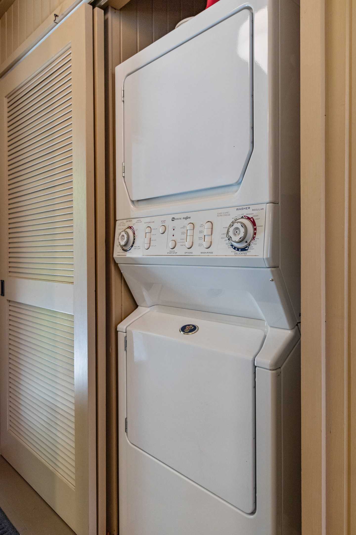 Conveniently tucked away just inside the entry, the laundry area keeps everyday necessities out of sight and the cottage feeling cozy.