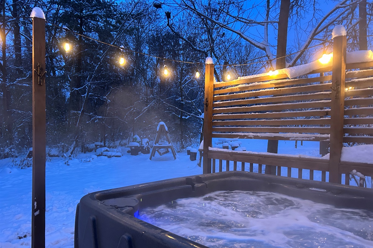 Snowy scene with a cozy hot tub.