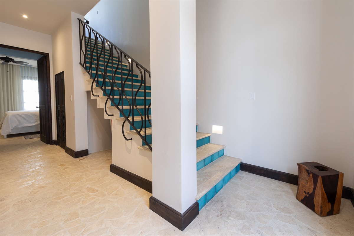 Stairs down to lower level bedroom area.