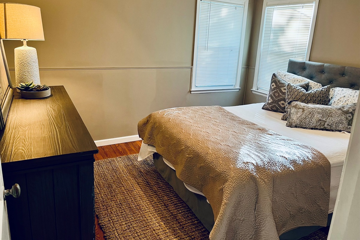 Our bedroom with a queen bed and natural light.