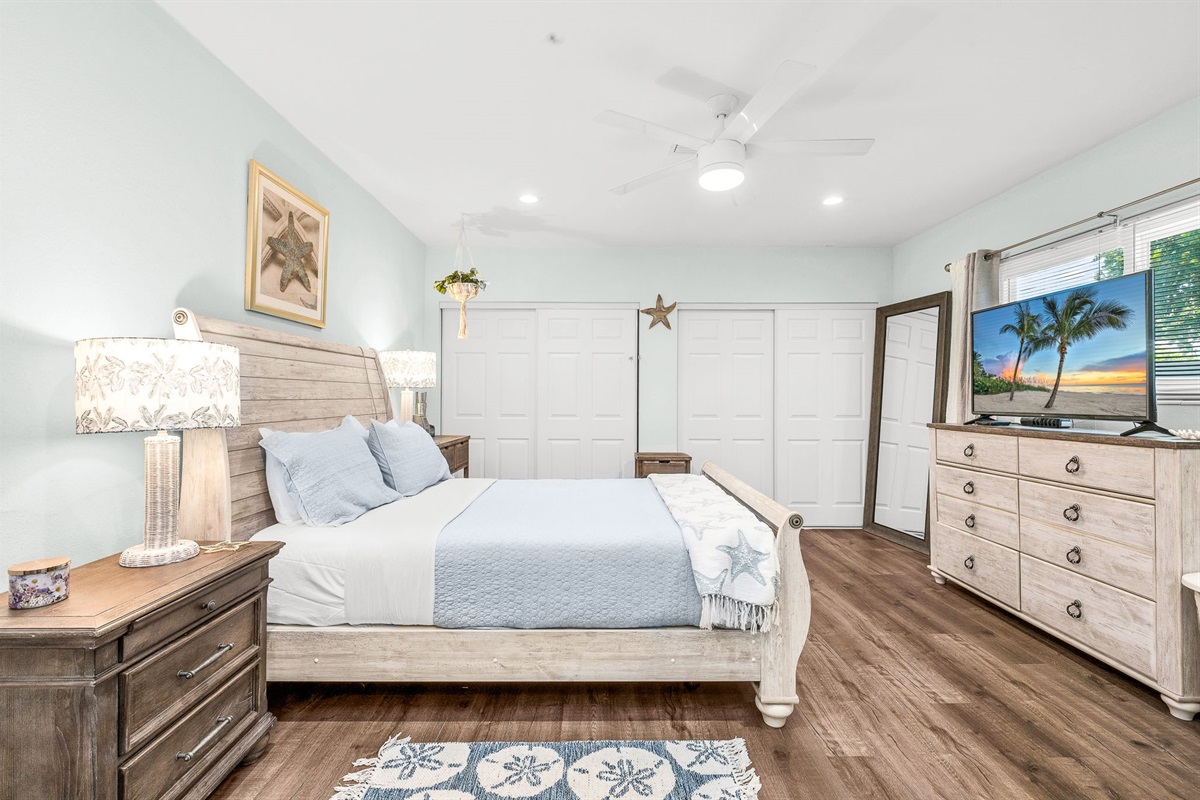 Spacious and peaceful master suite featuring a plush king bed, soft linens and elegant coastal decor.  Offering a cozy reading nook, and a calming palette - your private retreat for rest and relaxation.