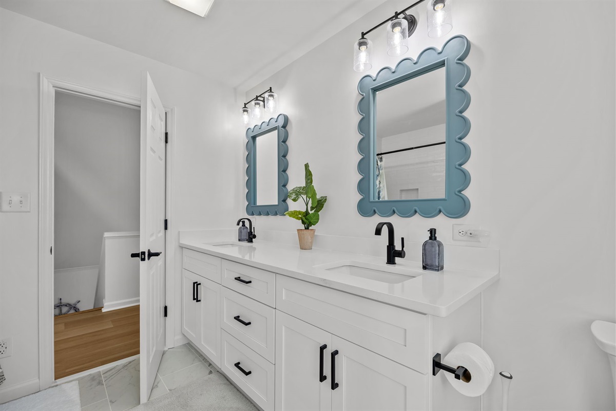 Second floor master bathroom with double vanity and coastal decor