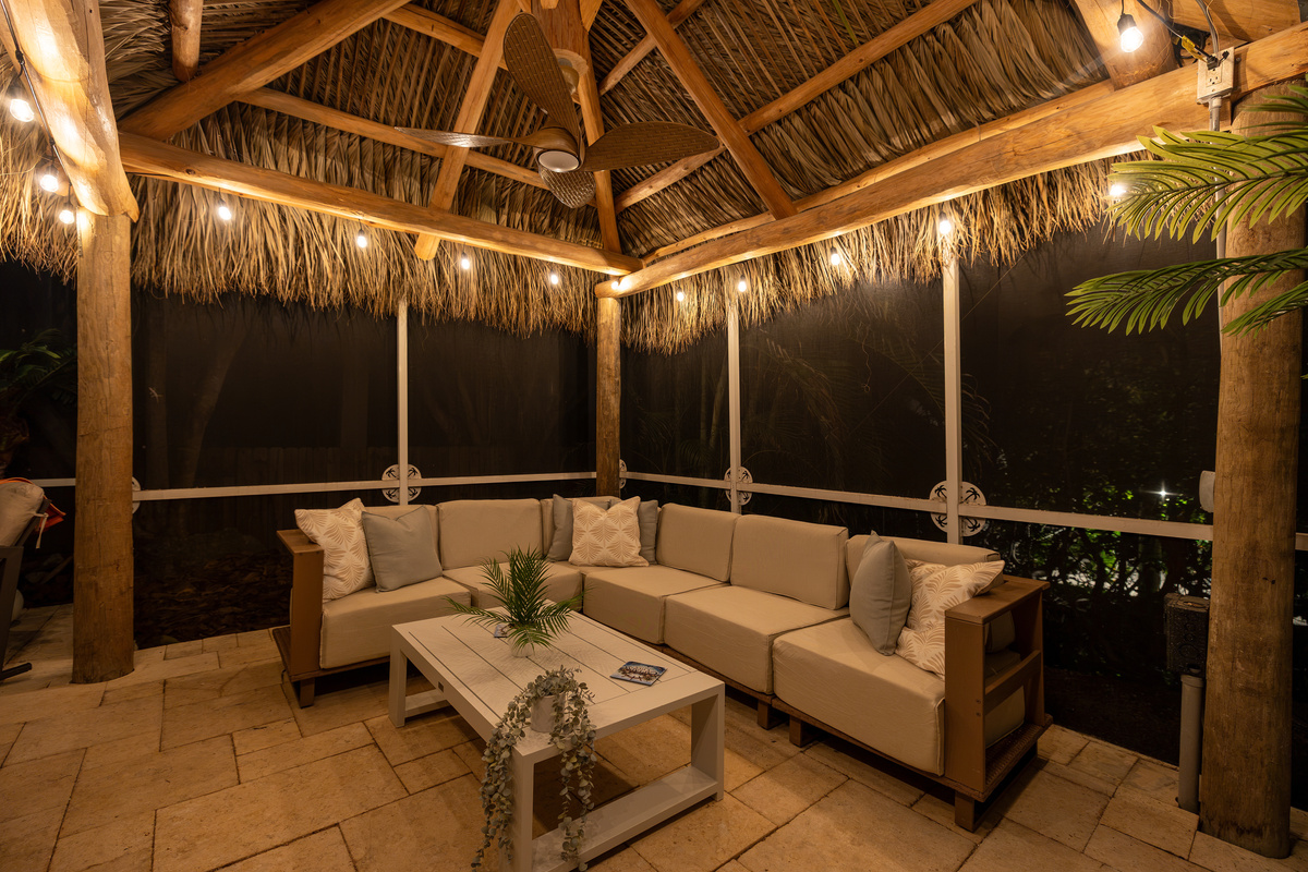 Lounge in the tiki hut next to the pool at night.