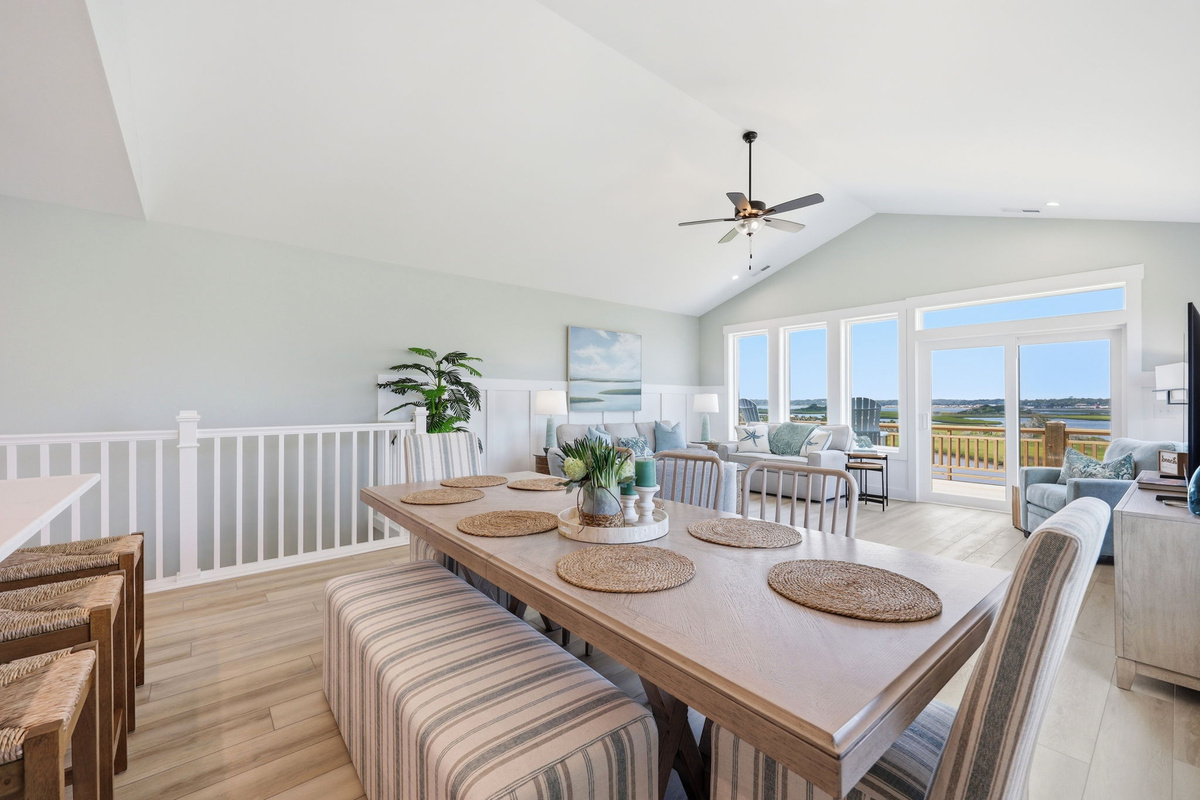 The open dining area keeps everyone together while showcasing beautiful views beyond the living room