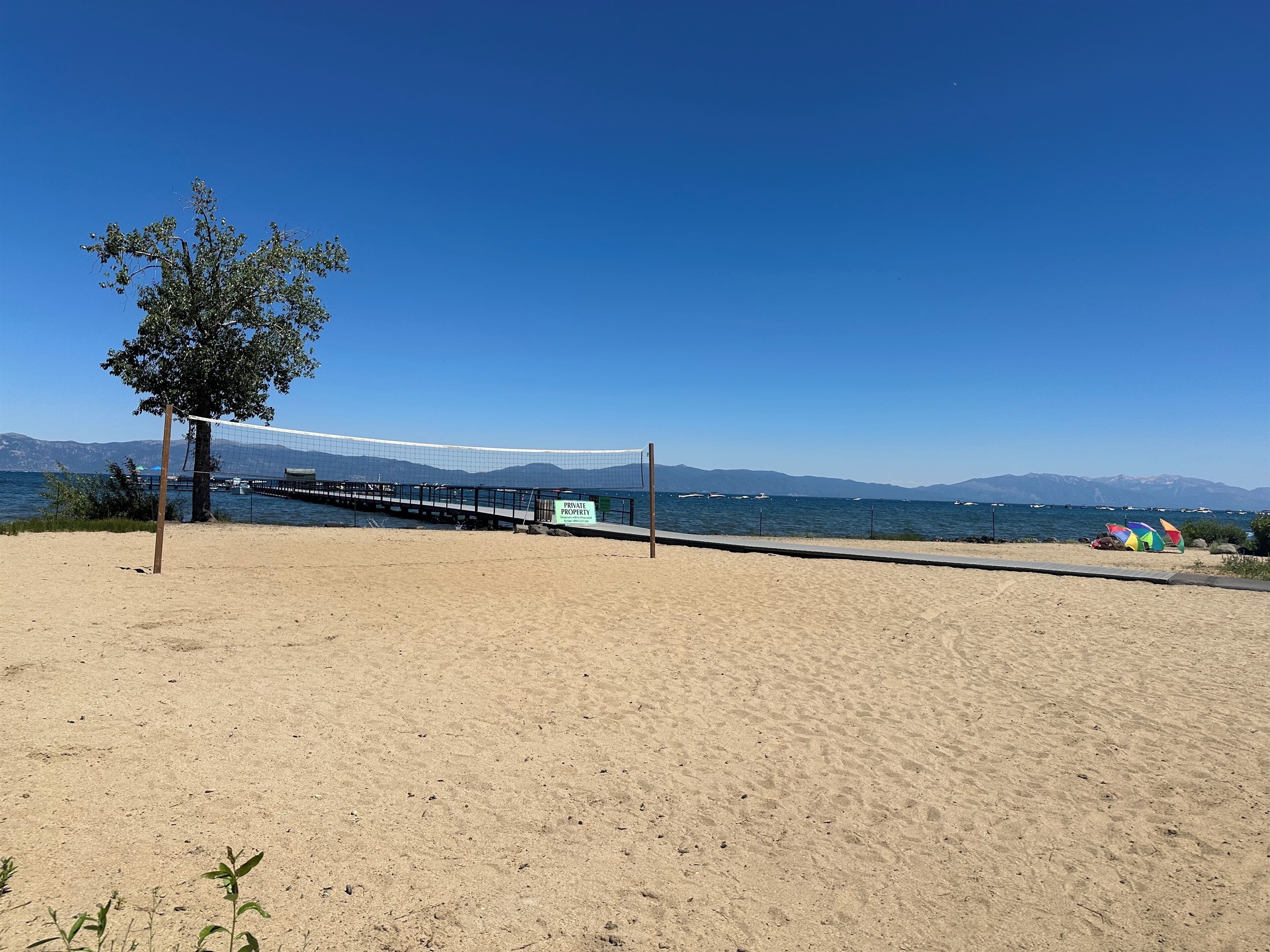Private beach and volleyball court next to the pier.