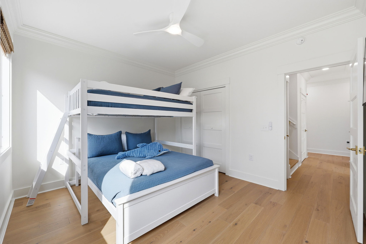 First-floor bunk room with full-over-queen bunk bed and clean modern finishes