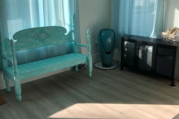 Experience instant Zen! ✨ Our first-floor entry features a calming Feng Shui water fountain and a unique turquoise bench. A serene sitting area designed for peace and style—the perfect welcoming touch to your Blue Mountain Beach retreat. 