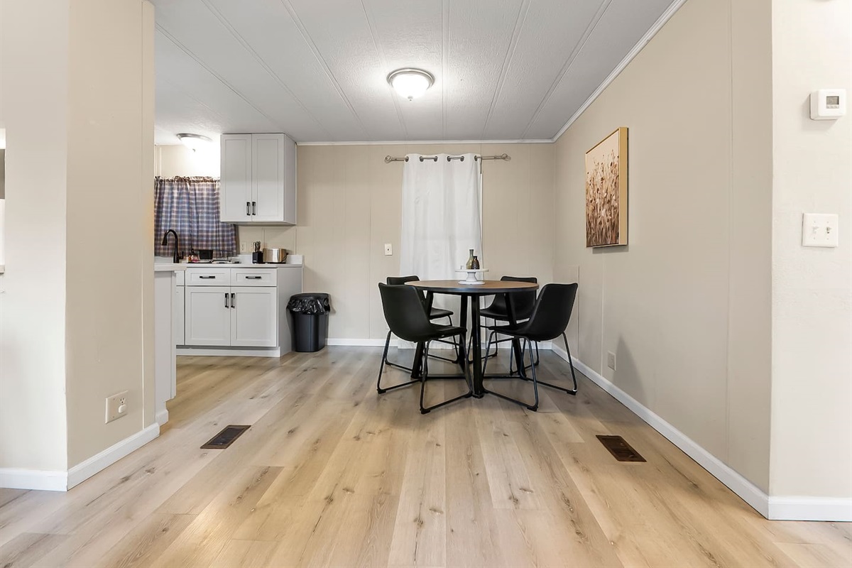 Dining area adjacent to the kitchen, making meal prep and serving easy and convenient.