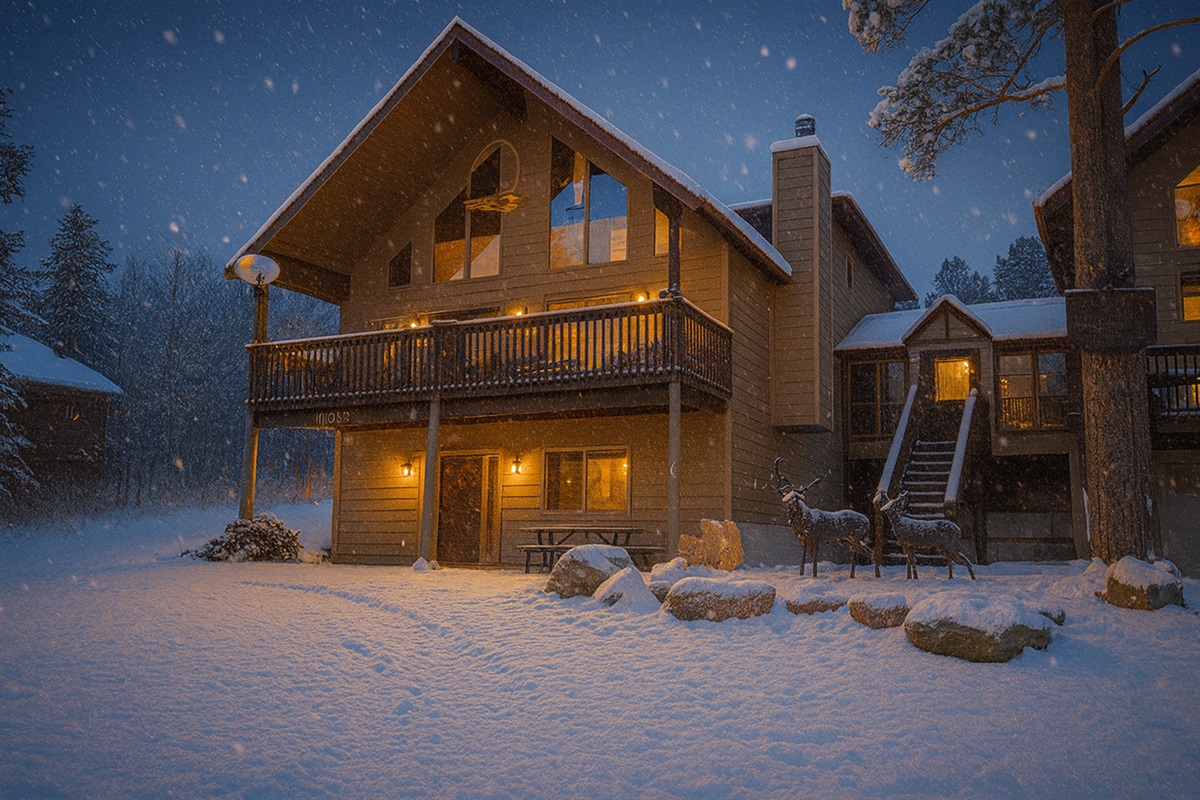 Soft lights glow against the snowy backdrop of this cozy mountain escape — the perfect place to gather after a day of adventure. Step inside, get the fire going, and enjoy the peaceful trees and starlit sky all to yourself.
