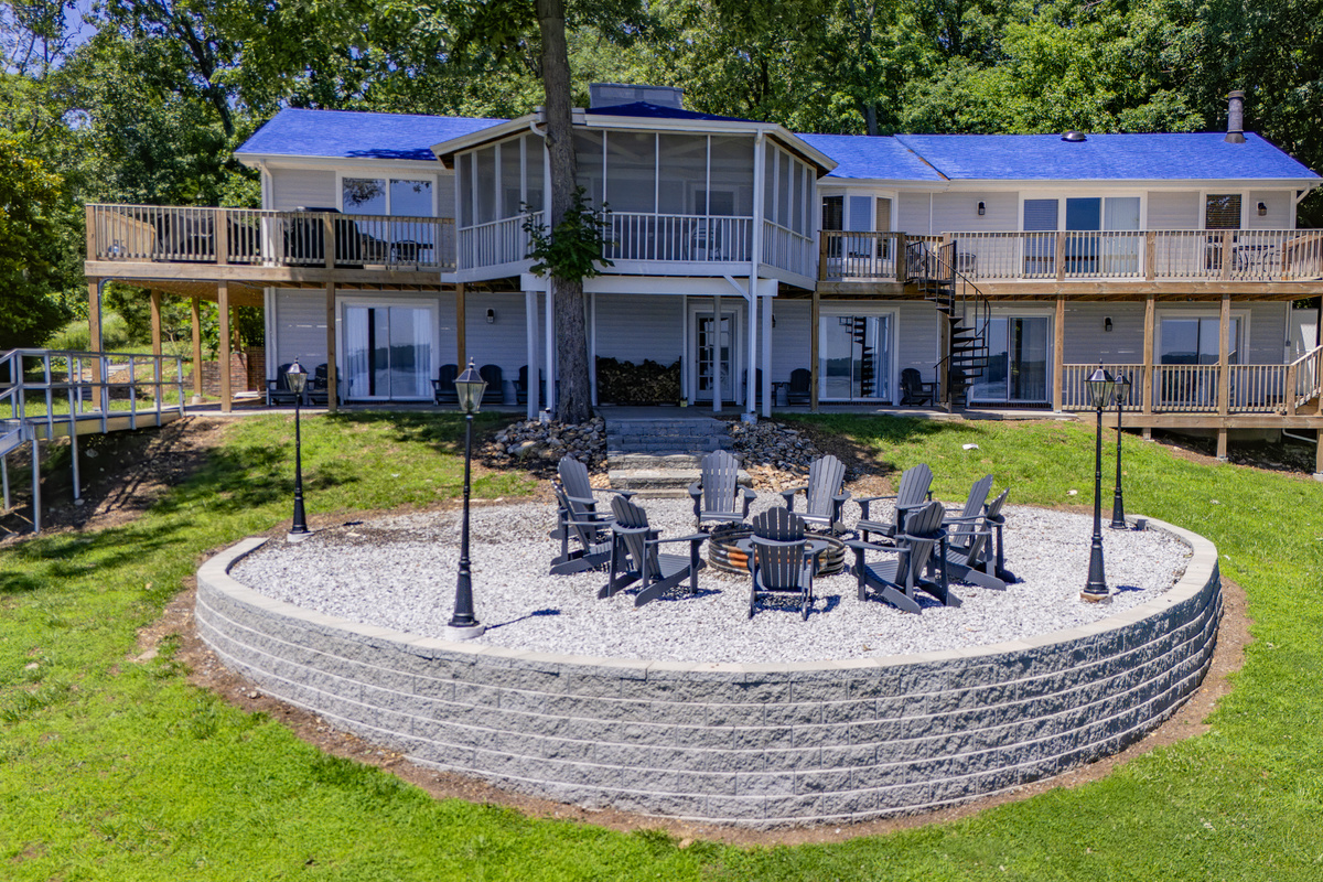 A close aerial captures The View’s expansive lake-facing exterior and large circular firepit gathering area.