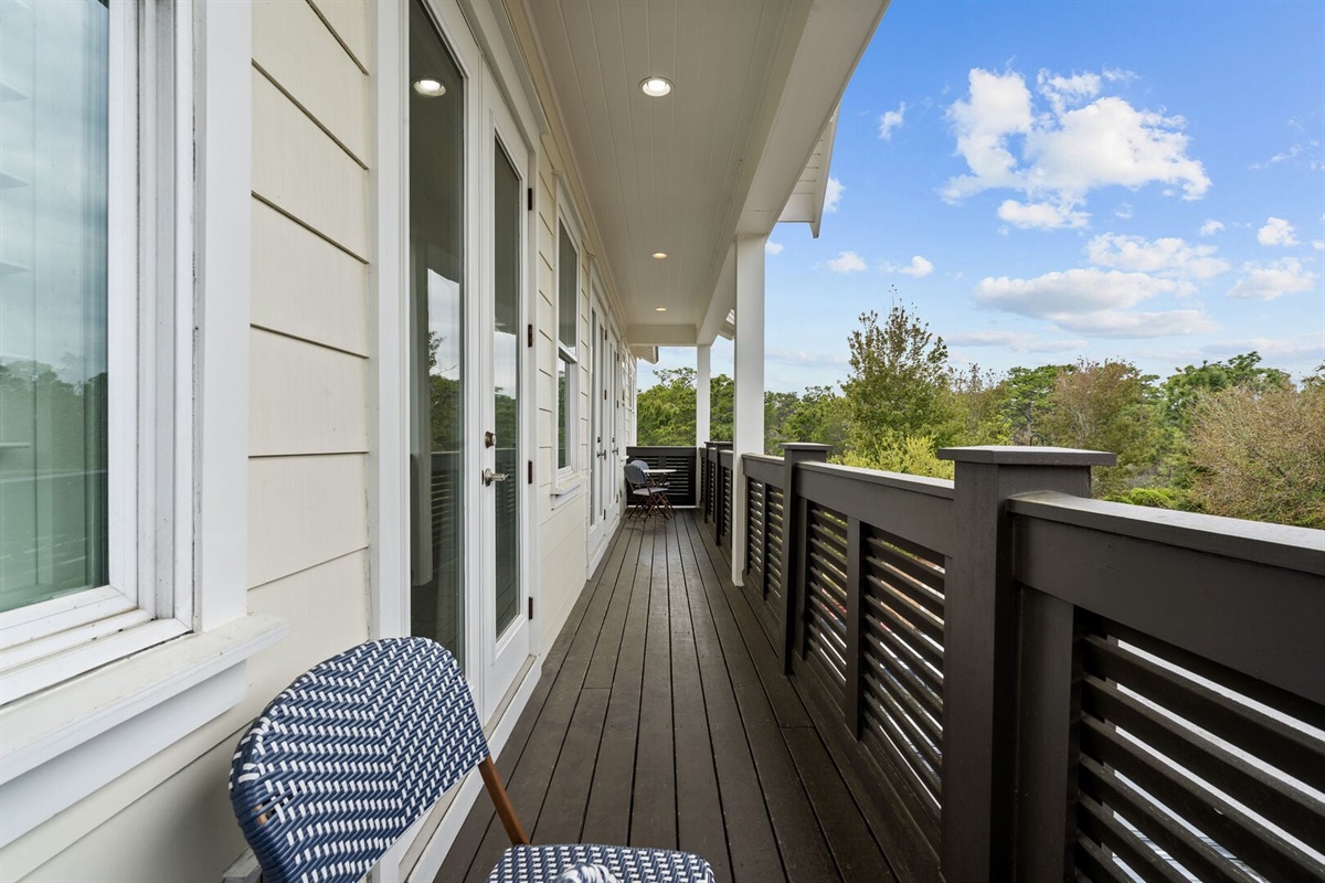 Covered balcony stretches the length of the unit.