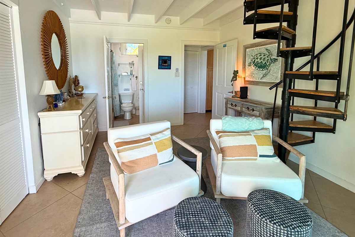 Guest room 1 has comfortable seating, an ensuite bathroom and loft bedroom with queen bed