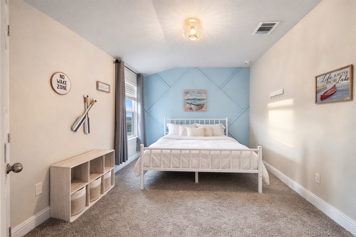Bedroom 2:
Queen bed with a comfortable layout and storage.