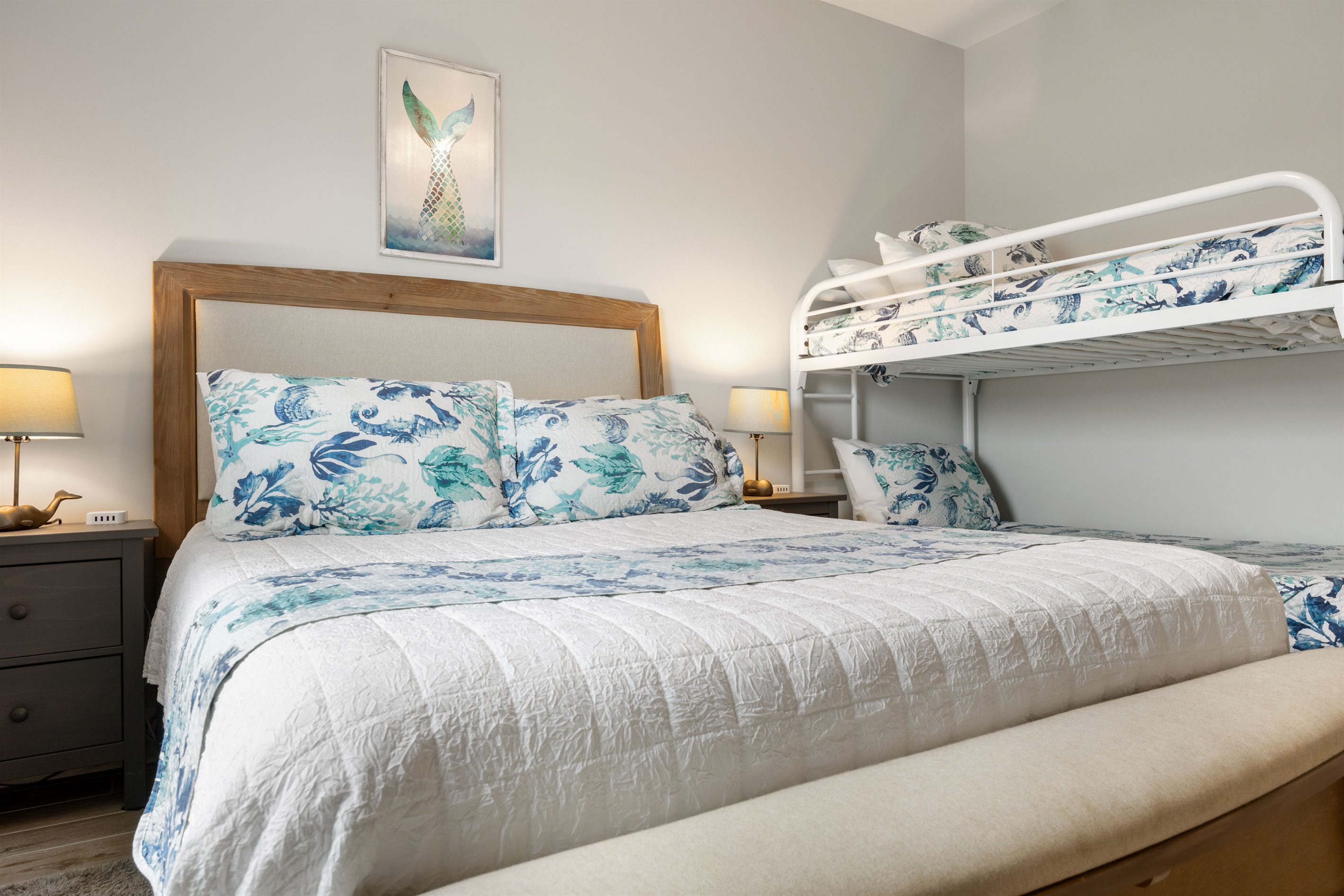 Hall bedroom on right side has a queen bed and a bunk bed