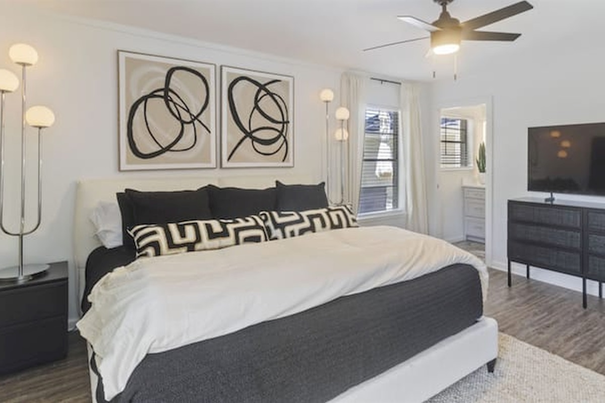 Spacious king bedroom with calming tones, soft lighting, and boutique-inspired design details.