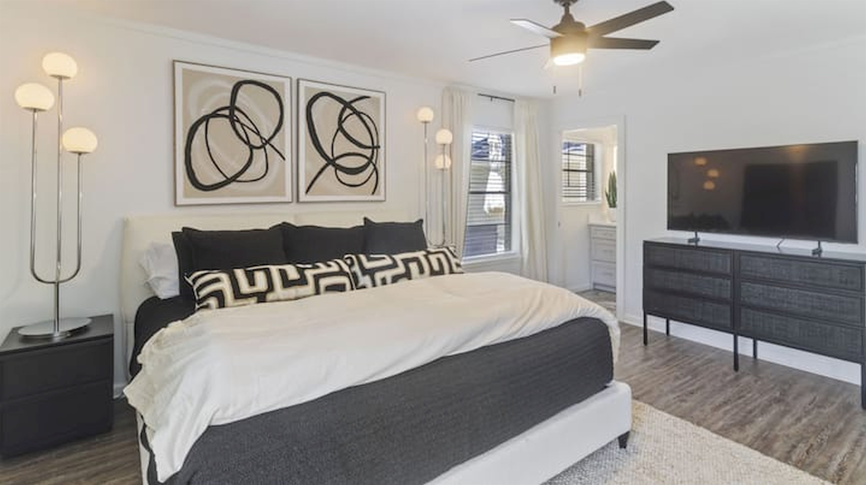Spacious king bedroom with calming tones, soft lighting, and boutique-inspired design details.